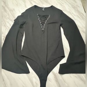Black bodysuit with tie up detail and sheer, flowy sleeves